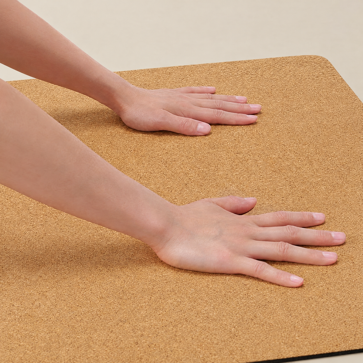 Hands pressing on the fine-grain natural cork surface