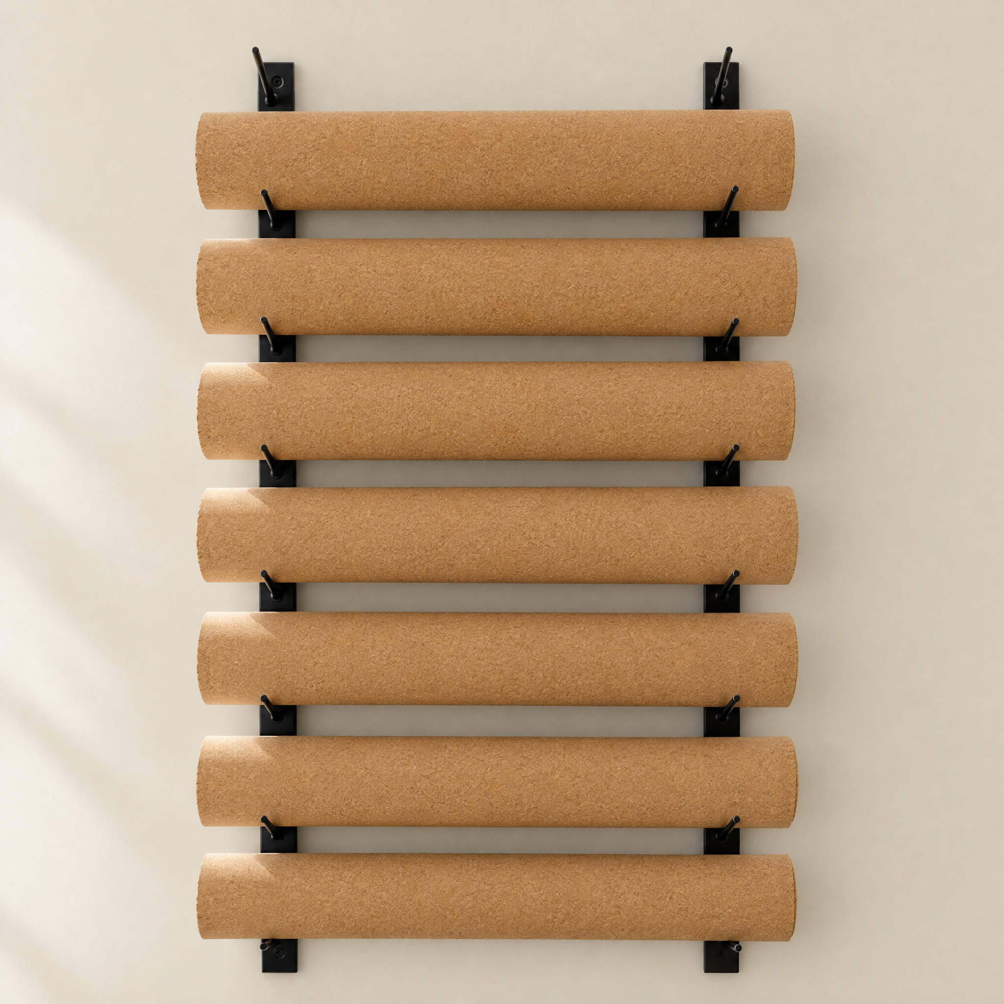 Rolled Essential cork yoga mats on a wall rack