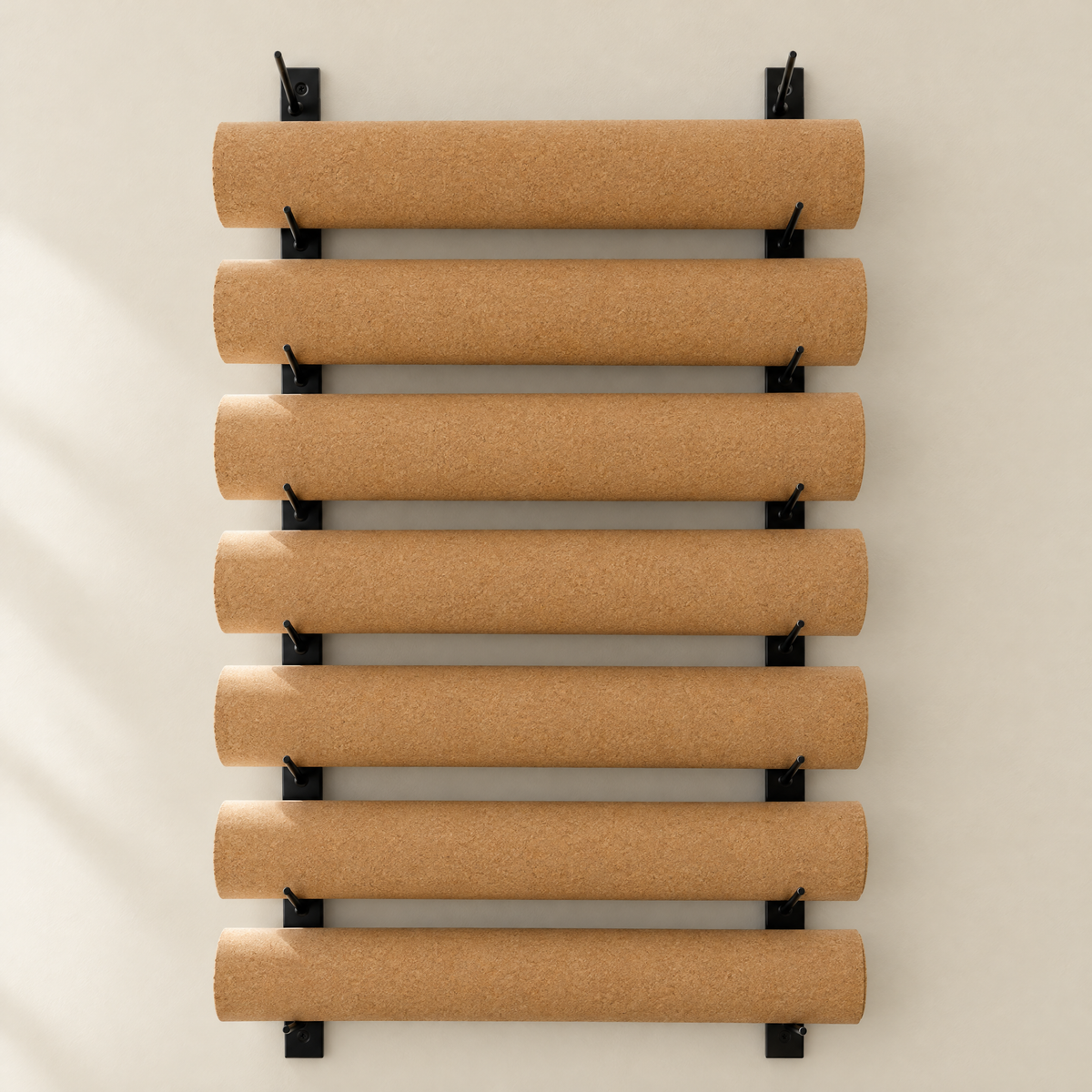 Rolled Essential cork yoga mats on a wall rack
